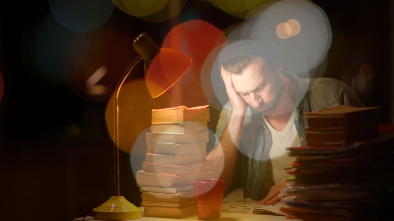 man leaning on hand studying late in dark room, displaying animated education charts and data icons