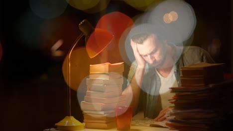 man leaning on hand studying late in dark room, displaying animated education charts and data icons