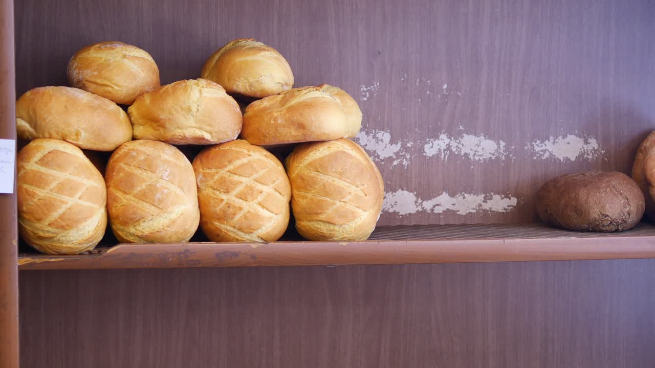 Freshly Baked Bread Loaves on a Wooden Shelf