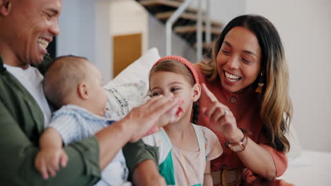 Happy-family,-baby-and-parents-play-on-sofa