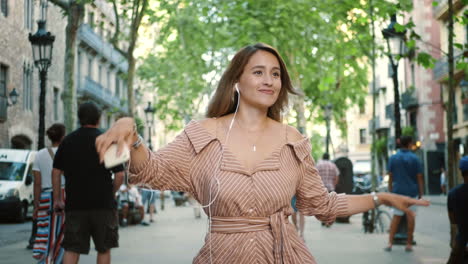 relaxed woman dancing in earphones. sexy girl flirting while outdoor walking.