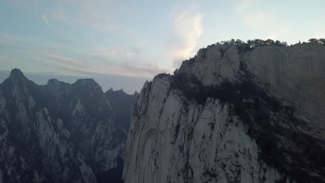 steep and barren, tall granite cliff wall of huashan mountain in china