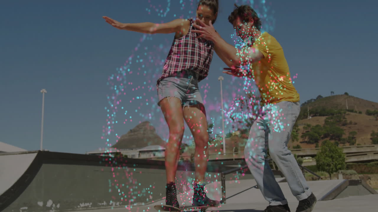 Couple standing on skate ramp, interacting with swirling confetti animations in technology context