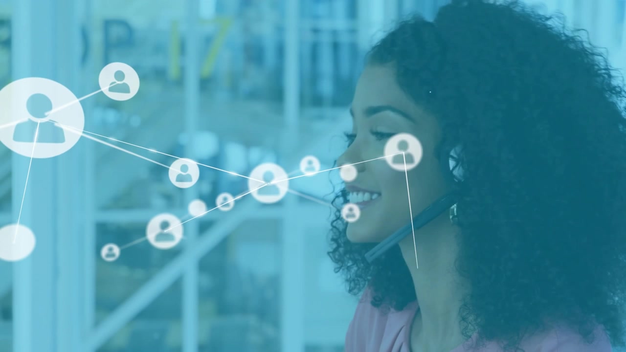 Customer service rep speaking via headset mic generating network map across glass partition
