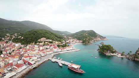 4k footage of fpv drone flying over waters towards a small harbour town in greece