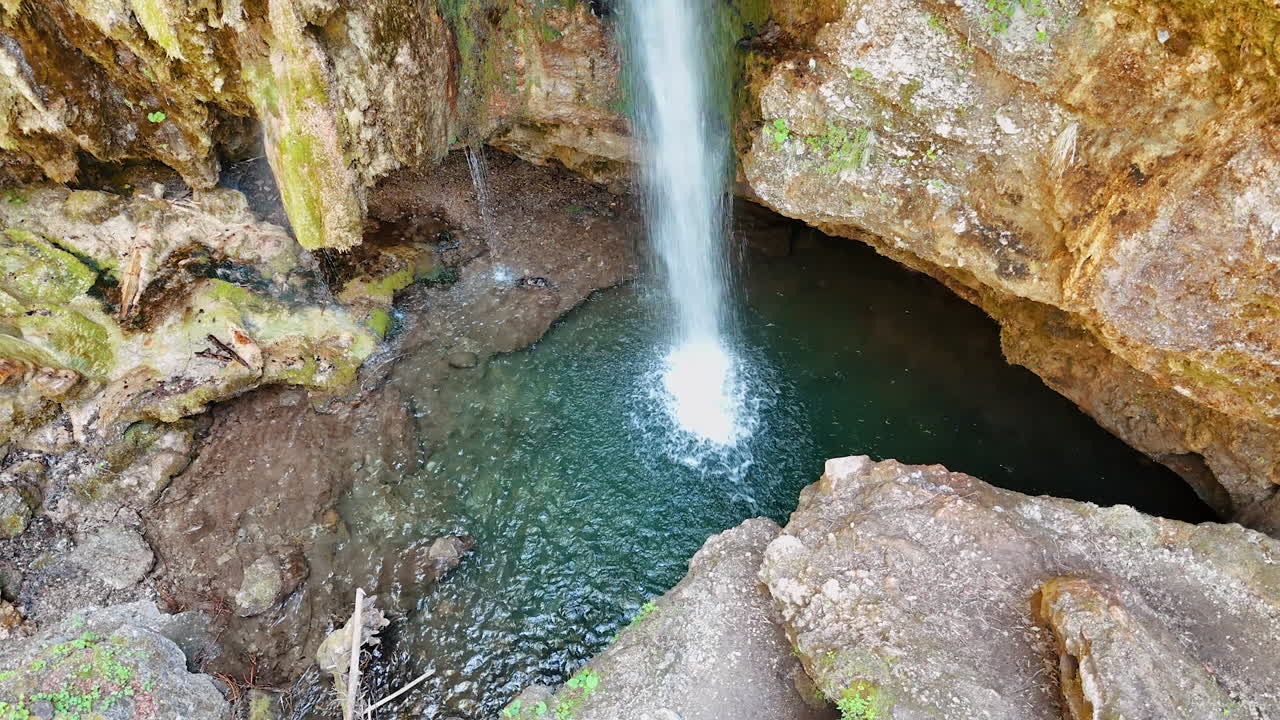 Little waterfall in the sandstone rocks. High angle view at the pond created in the mountains.