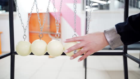 Newton's cradle showing laws of physics in motion. Museum of Science and newton pendulum