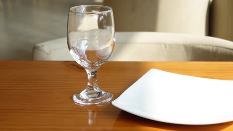 empty plate and glass on a wooden table