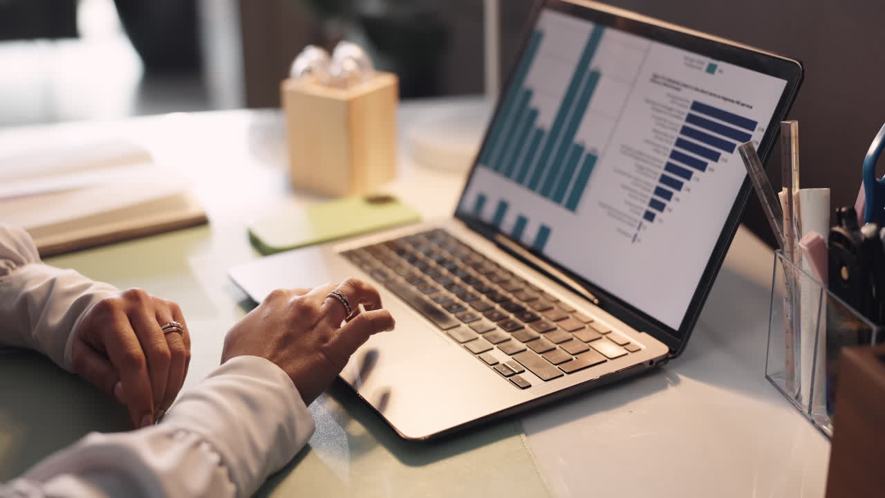 Woman analyzing charts on laptop