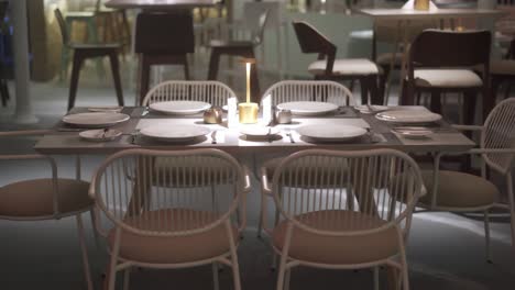 Front-view-of-stylish-and-light-dining-table-in-restaurant-close-up-shot,-Arc-shot