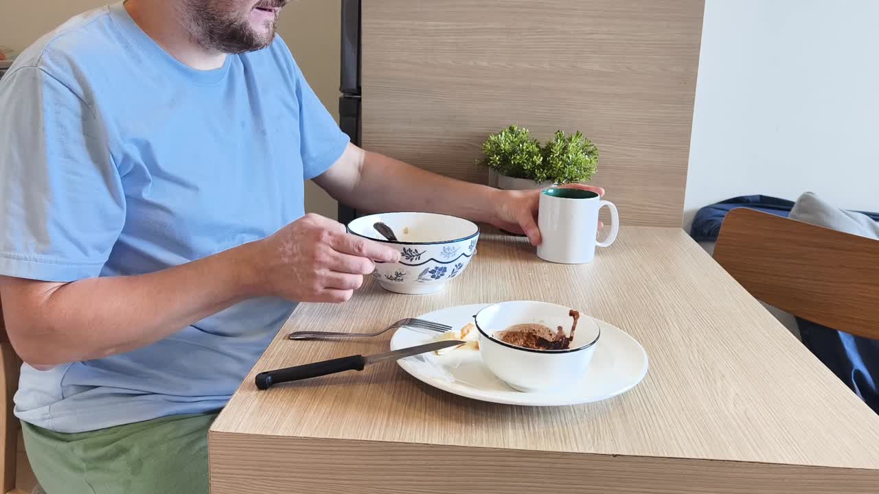 Man eating breakfast at table