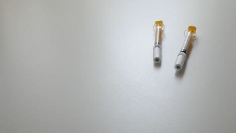 hands holding a syringe, preparing for medical use with a focused atmosphere