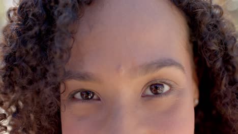 portrait of happy biracial woman looking at camera at beach house