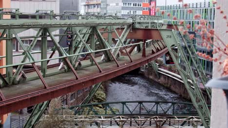 from window view the oldest monorail suspension railway in the world with train passing, in wuppertal germany