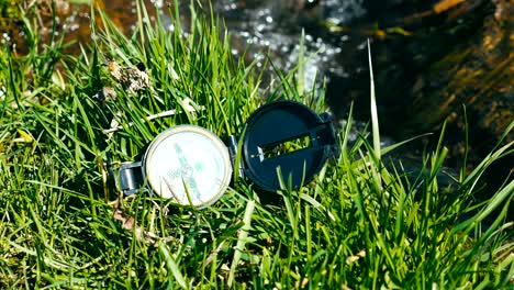 compass on the grass near litle stream