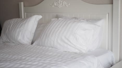 white bed with striped bedding