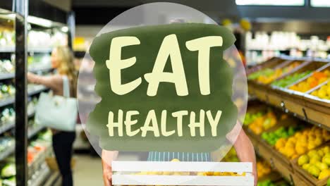 animation of eat healthy text on green, over man holding produce in food store