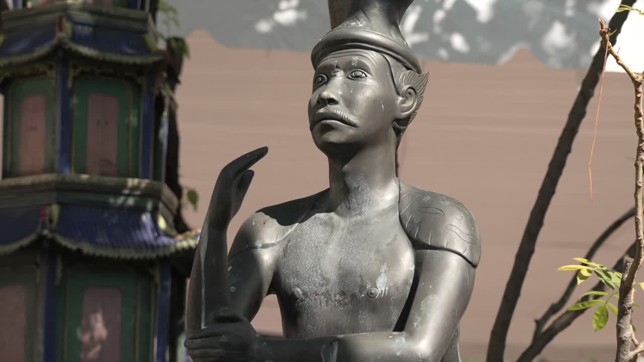 Stone statue at Wat Pho, Bangkok, Thailand, depicting a traditional figure in sunlight. Iconic temple sculpture symbolizing Thai culture, art, and heritage