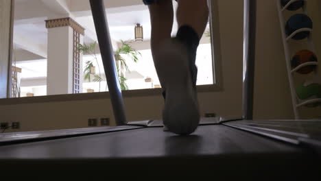 exercising on treadmill machine in the hotel gym