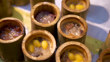 a close up of a traditional asian dish, sticky rice in bamboo