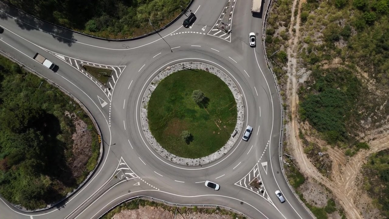 Drone Perspective of busy Highway Junction with Roundabout During Peak Traffic Flow