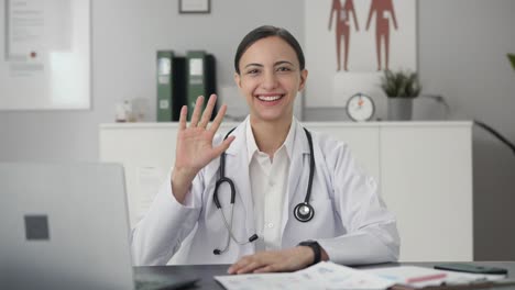 happy indian female doctor waving hi