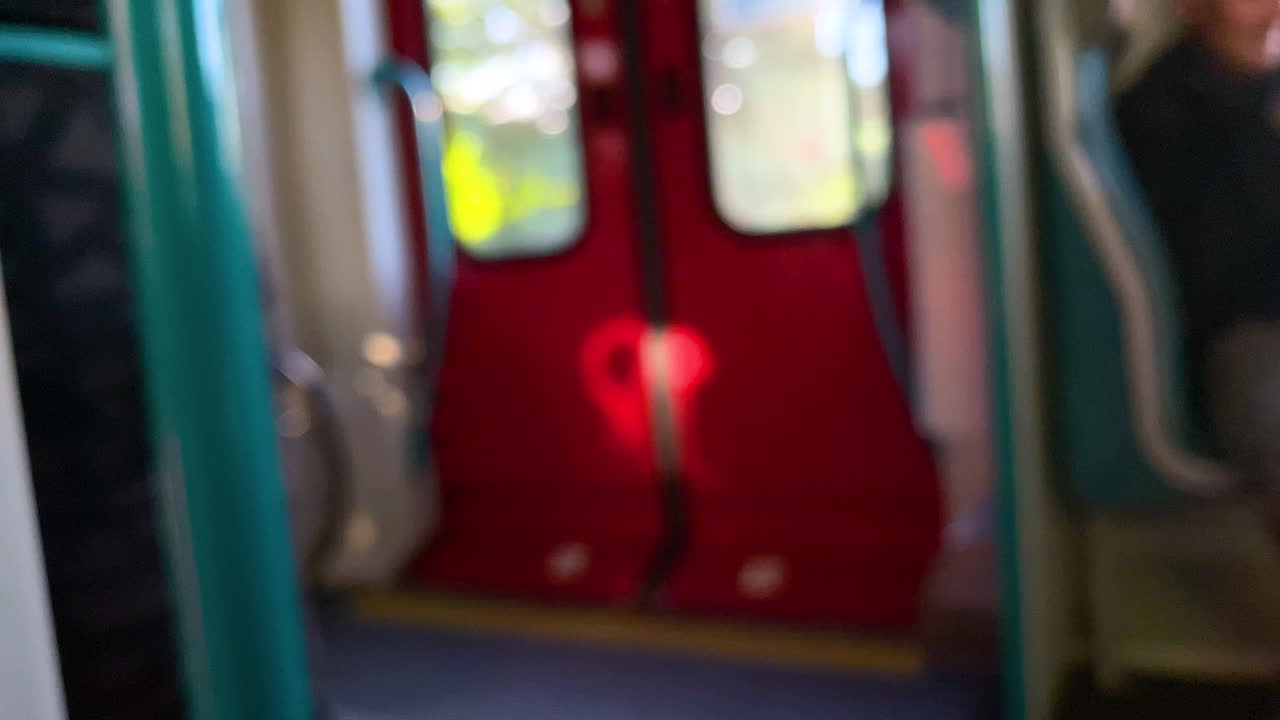 Defocused Shot Of Red Door Of A Passenger Train Moving In Slow Motion At Daytime