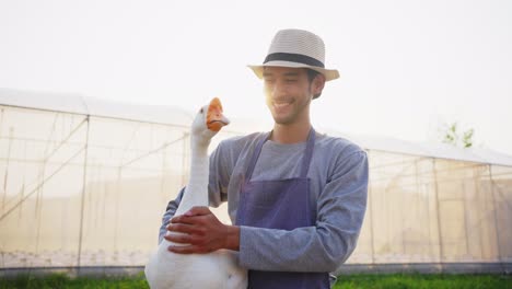 farmer holding a goose