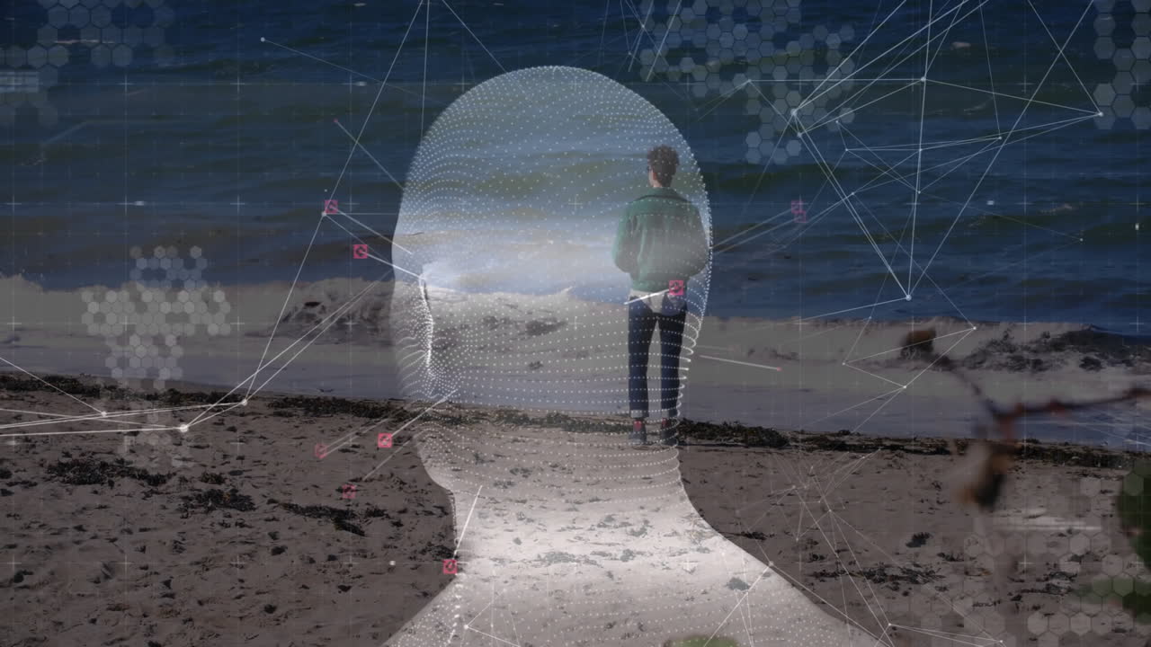 Man standing on seashore, using technology with 3D wireframe head, network lines and data icons
