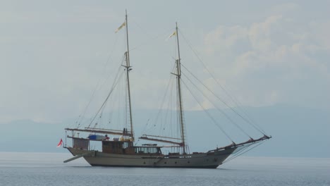 two-masted-yacht-anchored-near-Kri-Island,-Raja-Ampat,-Indonesia