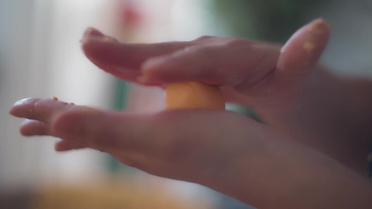 Chef's hands rolling cheese buns