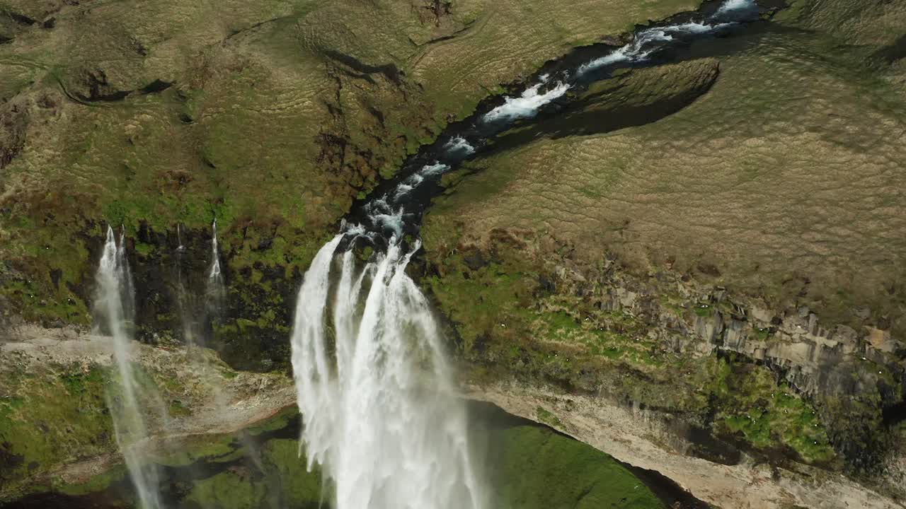 Stunning Seljalandsfoss waterfall in Iceland with water flowing from cliff