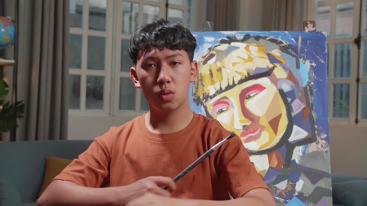 Asian Artist Boy Holding Paintbrush Mixed Colour Wipe The Sweat Before Crossing His Arms And Smiling After Finish Painting A Girl On The Canvas