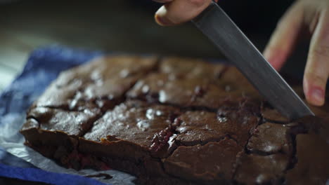 male hands cutting chocolate cake on slices. cut cake on pieces. cutting cake