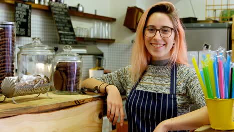 Beautiful-waitress-standing-at-the-cafe-counter-4k