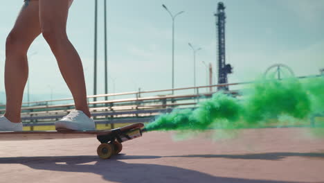 woman skateboarding with green smoke