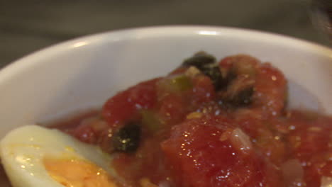preparing a tomato and egg salad