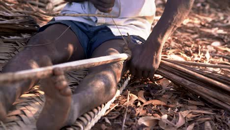 native african of comoros making wandza element for his roof