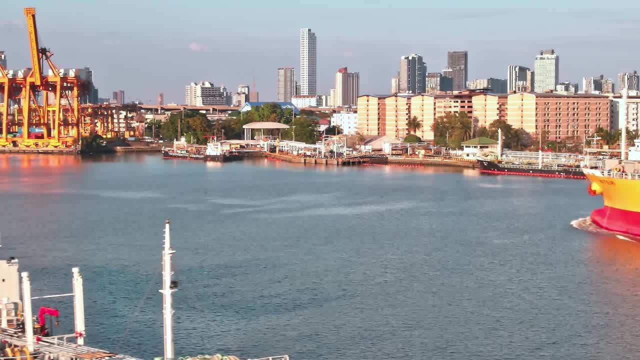 View of ships and city buildings in Bangkok during the day