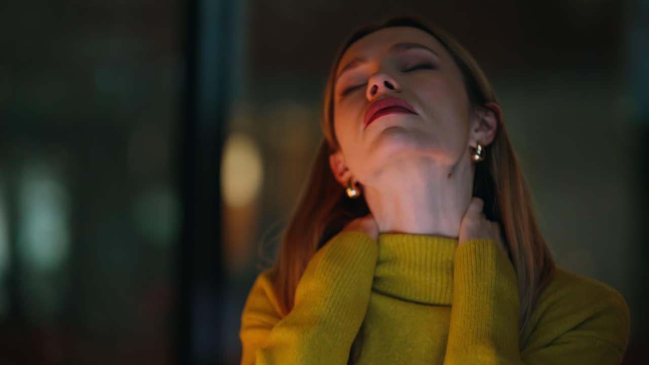 Closeup woman working overtime sitting dark workspace. Tired businesswoman