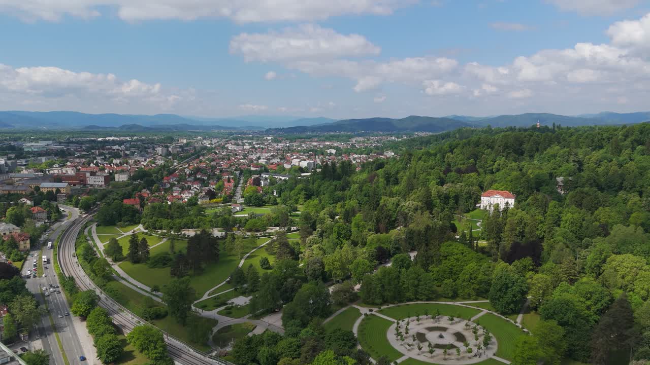 Aerial establishing fly green urban location next to city streets in Park Tivoli Town in Centre of Ljubljana
