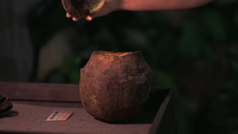 Hand-opens-Amazonian-coconut-illuminated-indoors