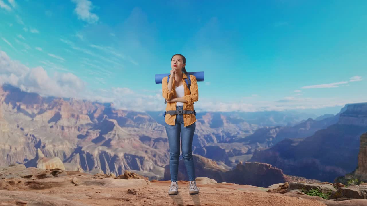Full Body Of Asian Female Hiker With Mountaineering Backpack Thinking About Something And Looking Around While Traveling At The Top Of Mountain