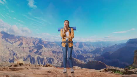 full body of asian female hiker with mountaineering backpack thinking about something and looking around while traveling at the top of mountain