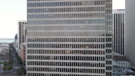 Facade-of-a-modern-office-building-with-a-repetitive-pattern-of-windows-and-architectural-details,-urban-corporate-background