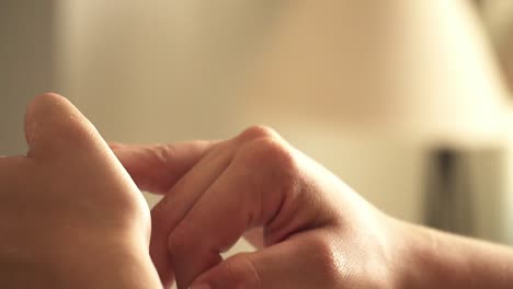 Slow-motion-handheld-shot-of-a-bride's-hand-sticking-glittery-accessories-on-her-nails-before-her-wedding-with-her-husband