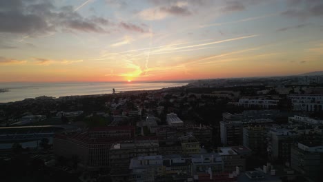 aerial view of a sunset over lisbon bay near the tagus river, casting warm hues across the tranquil waters and cityscape