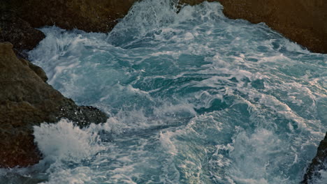 stormy ocean breaking rocks outside closeup. foamy sea waves crashing by stones