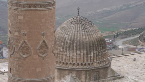 As-the-camera-zooms-out,-we-see-the-minaret-and-dome-of-the-great-mosque-of-Mardin