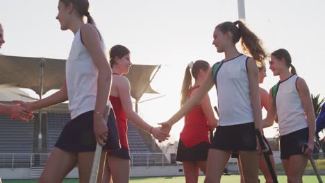 Female-hockey-players-shaking-hands-each-other--on-the-field